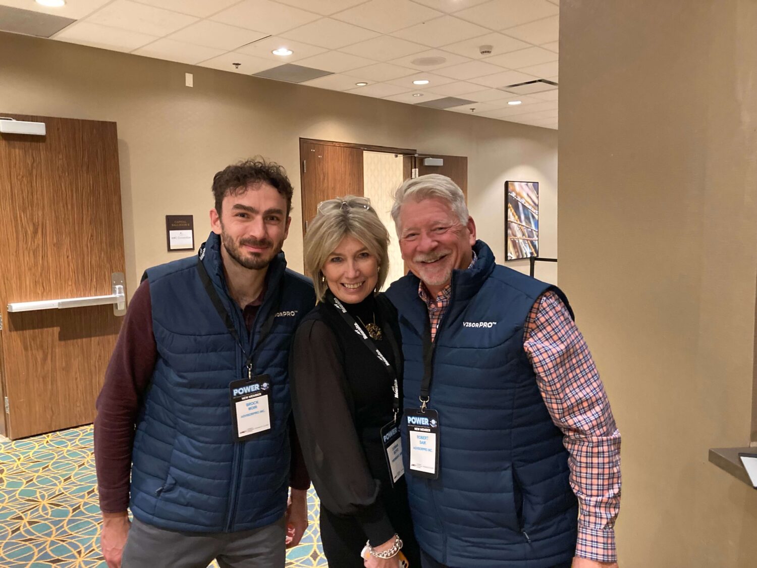 From left to right, Brock Moir, Donna, and Rob Saik, smile towards the camera.